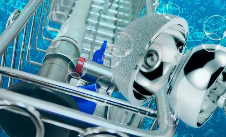 Close-up of metallic precision parts and a rack submerged in a bubbly blue liquid, evoking effective ultrasonic cleaning.
