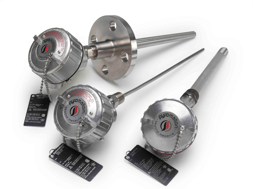 Close-up of metallic Pyromation RTD temperature sensors with probes and connection heads, signaling accurate industrial control.