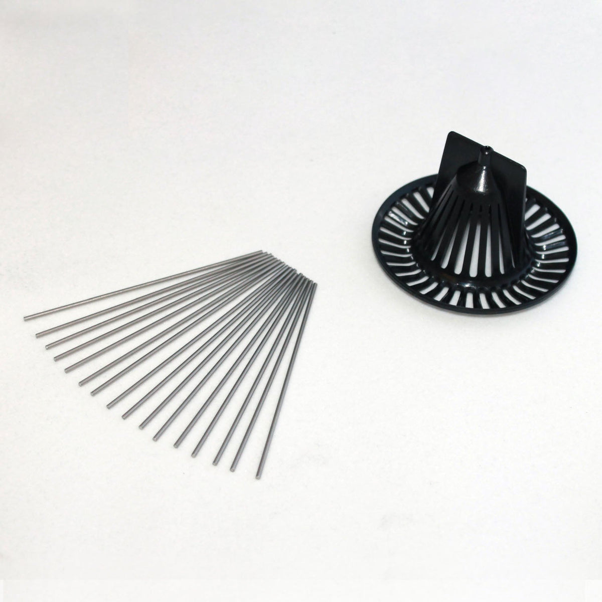 Bird spike and debris screen kit by Davis Instruments, with several metal rods next to black plastic drain cover.
