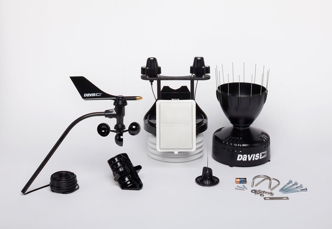 Black cabled Vantage Pro2 Plus Sensor Suite Weather Station by Davis Instruments, with solar panel, rain collector, and anemometer parts.