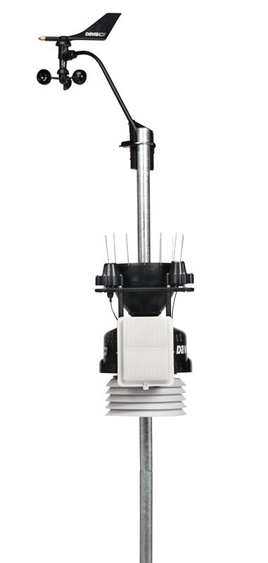 Cabled weather station by Davis Instruments with wind vane, rain collector, and temperature sensor mounted on a metal pole.
