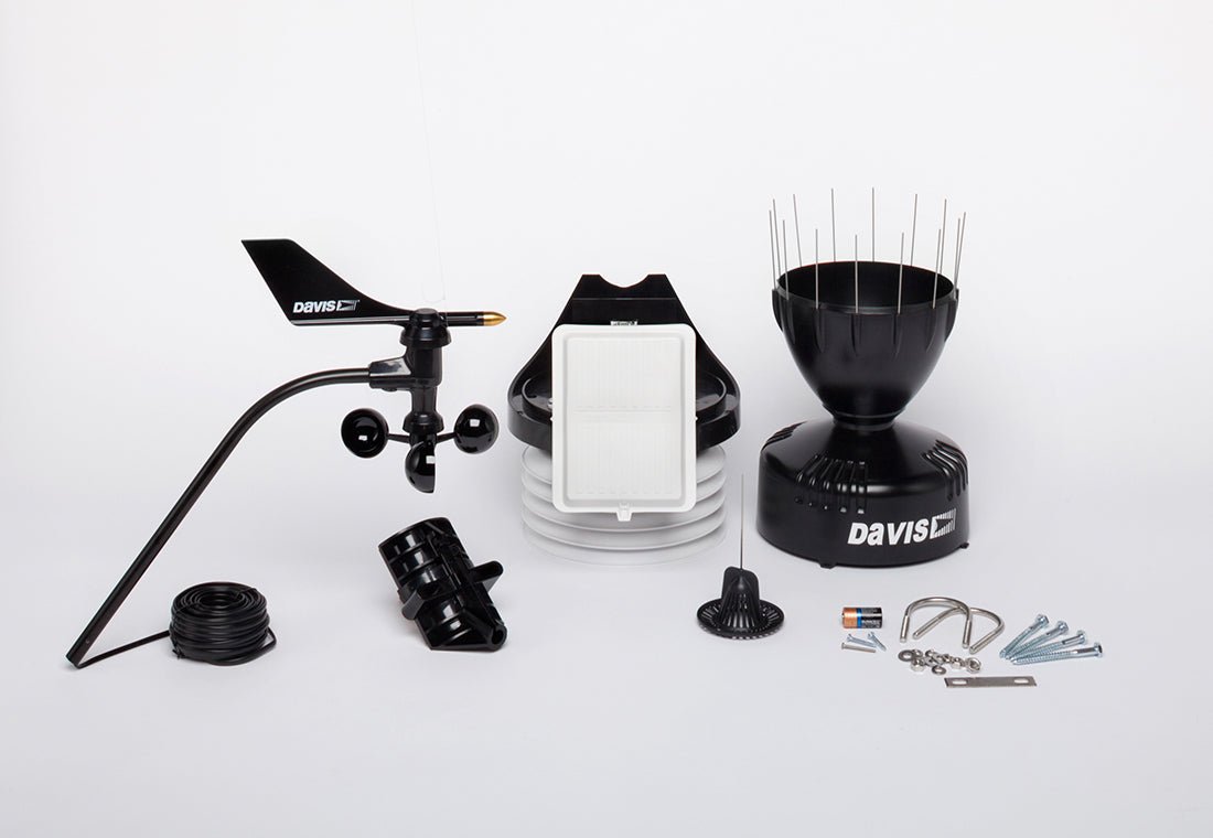 Black cabled sensor suite weather station by Davis Instruments featuring a solar panel and rain collector.