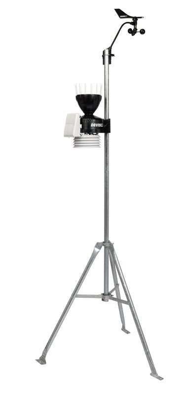 Weather station by Davis Instruments with wind vane, rain collector, and temperature sensors atop a galvanized tripod.

