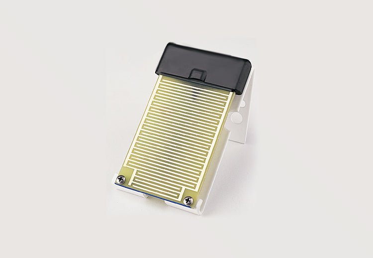 Leaf wetness sensor for Vantage Pro2™ and EnviroMonitor® by Davis Instruments, featuring gold-colored serpentine lines and a white plastic mounting bracket.
