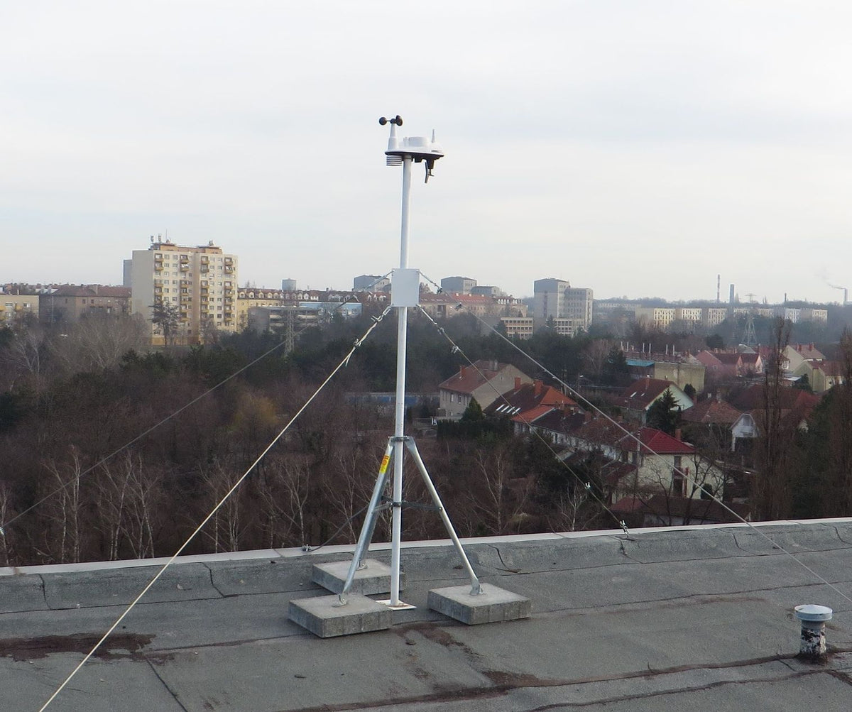 Mounting tripod by Davis Instruments set up on a rooftop with a meteorological sensor attached.