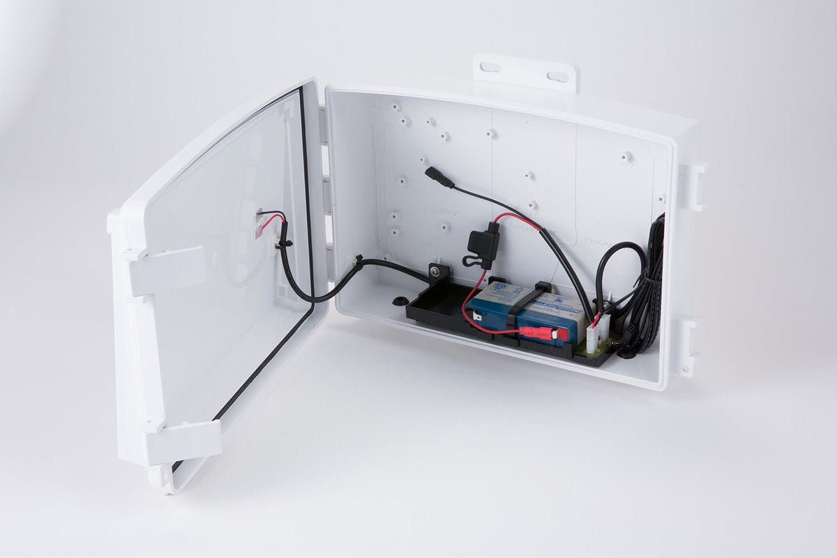 Accessory solar power kit by Davis Instruments inside a white plastic casing with wires and batteries.