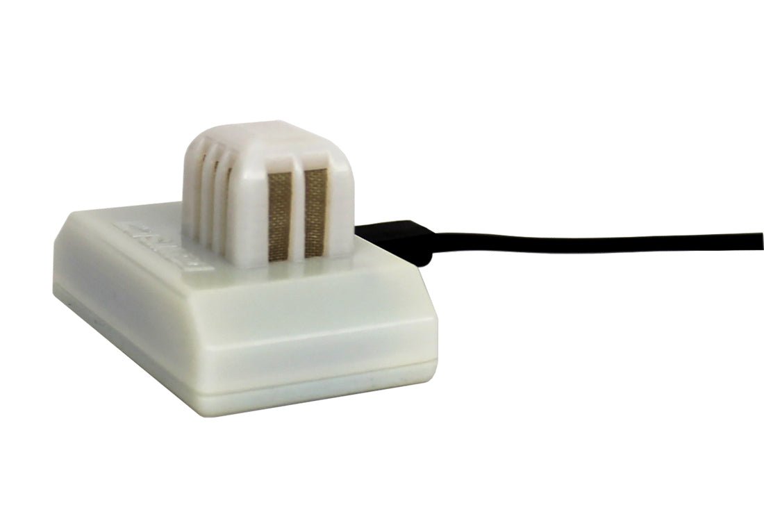 White temperature and humidity sensor by Davis Instruments with ventilation slots and a black cable.
