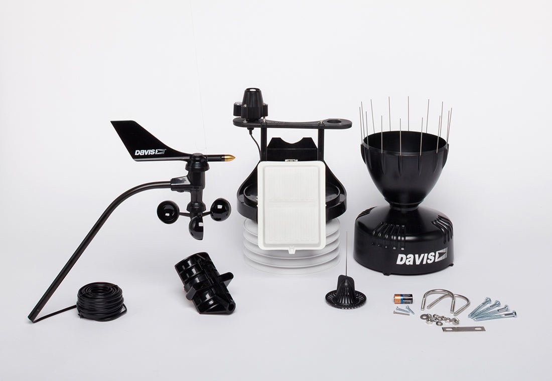 Weather station sensor suite by Davis Instruments with wind vane, rain collector, and cabled sensor array.