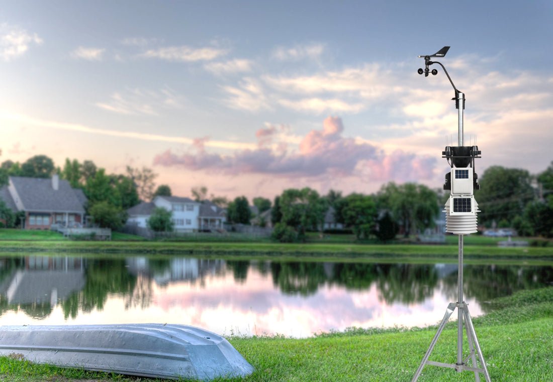 Wireless professional weather station by Davis Instruments with a fan-aspirated radiation shield on a tripod.