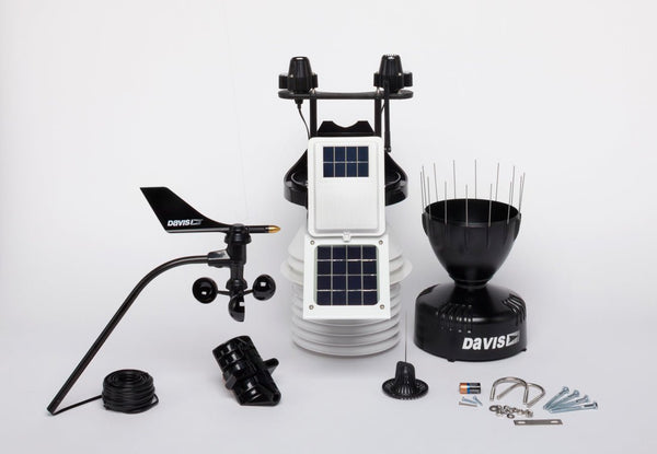 Wireless weather station with fan-aspirated radiation shield by Davis Instruments, featuring anemometer, rain collector, and solar panels.