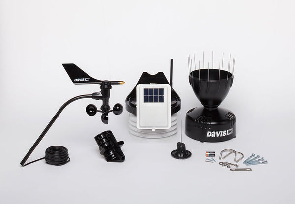 Black wireless weather station by Davis Instruments with an anemometer, console, and rain collector.
