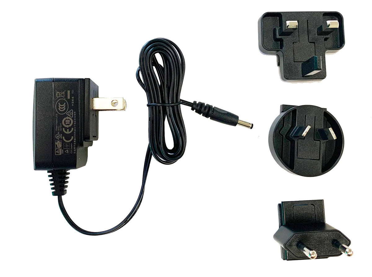 Black AC adapter with interchangeable prongs by Sper Scientific, featuring a coiled cable and different plug head options.